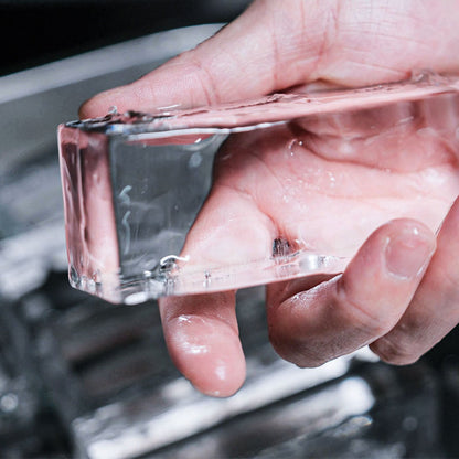 A Collins Spear shape clear ice block in a hand