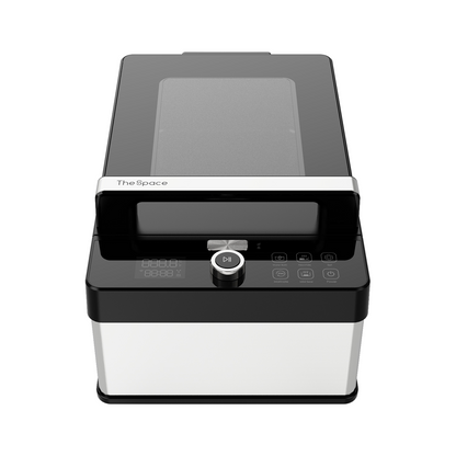 Black and silver device with a glass lid and control panel on a white background